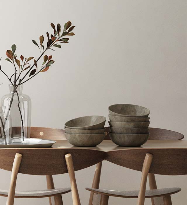 A table with bowls and vases on it