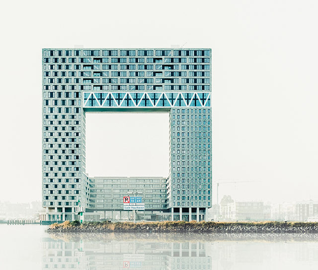 A large building with many windows and a square shaped structure.