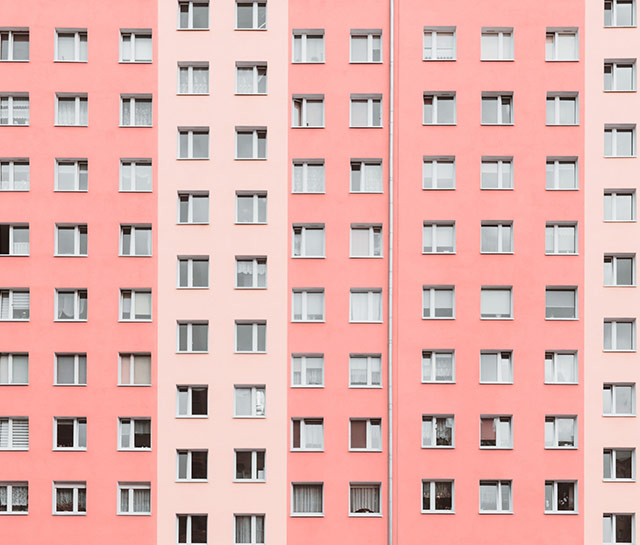 A pink building with many windows in the background.