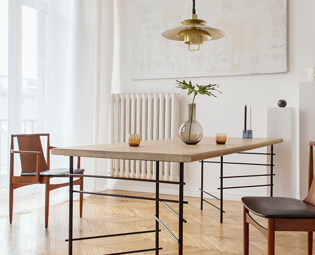 A dining table with metal legs and wooden top.