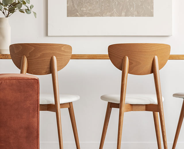 Two chairs are sitting in front of a table.