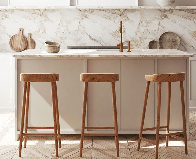 Three stools in front of a kitchen counter.