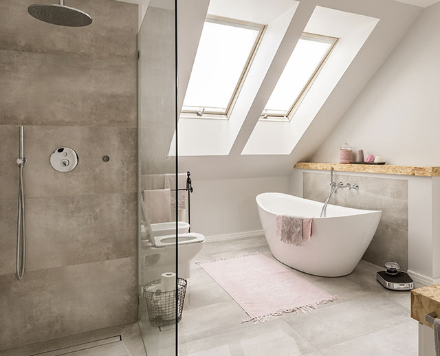 A bathroom with a large white tub and shower.