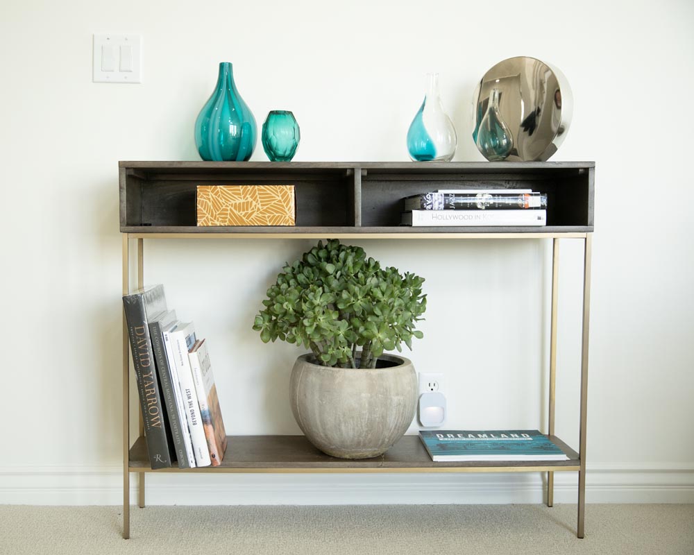 A table with books and vases on it